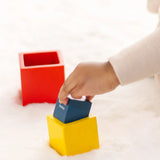 Child playing with the PlanToys nesting boxes.