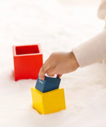 Child playing with the PlanToys nesting boxes.