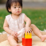 Child playing with the PlanToys nesting boxes.