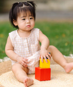 Child playing with the PlanToys nesting boxes.
