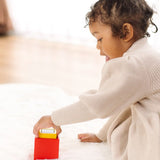 Child playing with the PlanToys nesting boxes.