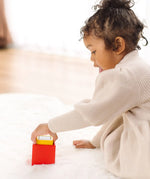 Child playing with the PlanToys nesting boxes.