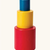 PlanToys Nesting Cylinders 3 piece wooden toy. Red, yellow and blue coloured wooden cylinder shaped wooden pieces that nest inside each other. 