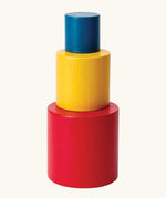PlanToys Nesting Cylinders 3 piece wooden toy. Red, yellow and blue coloured wooden cylinder shaped wooden pieces that nest inside each other. 