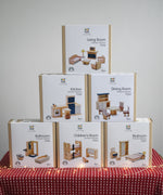 Six boxes of PlanToys wooden dollhouse furniture, stacked in a large discounted bundle at Babipur. 