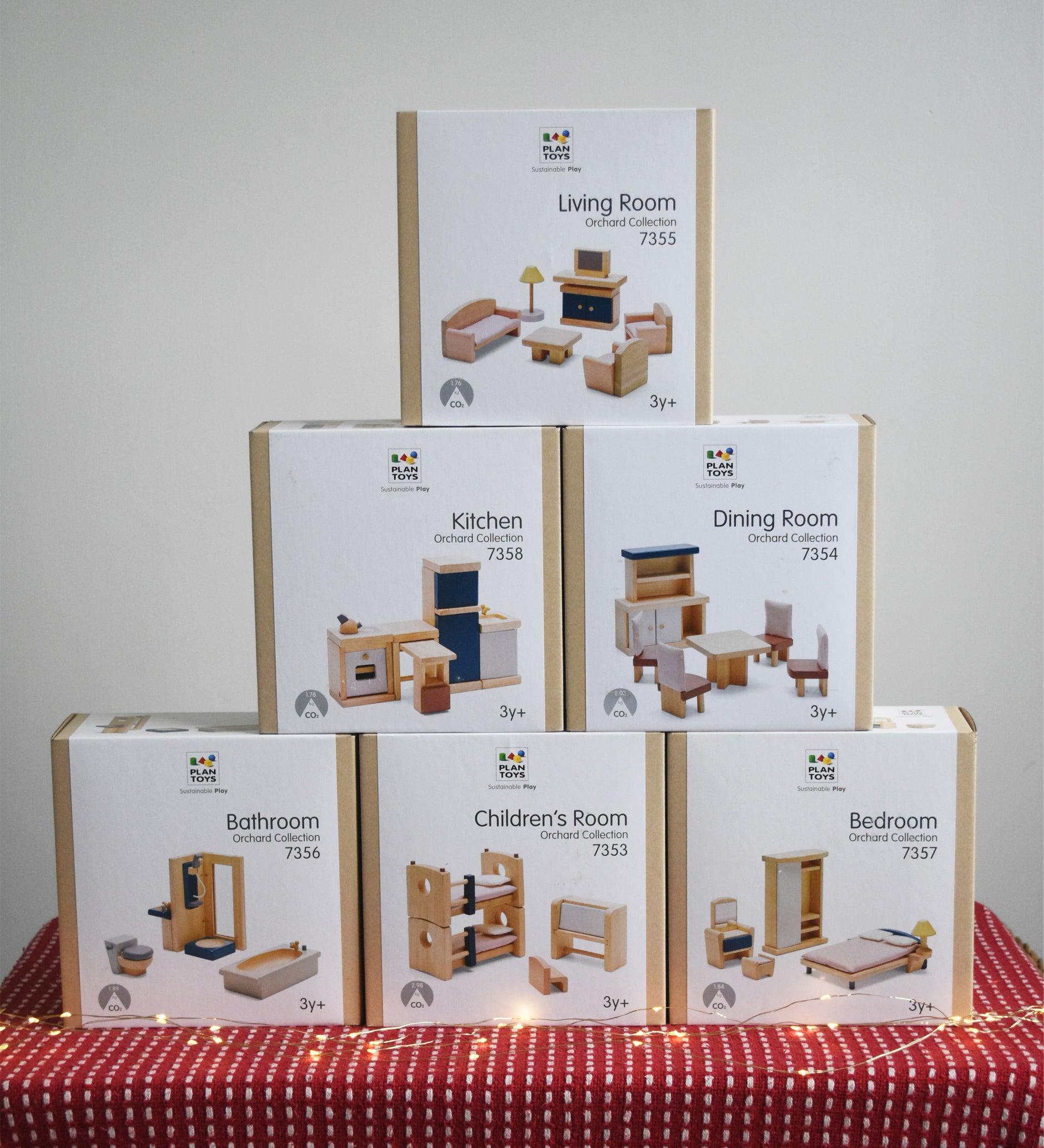 Six boxes of PlanToys wooden dollhouse furniture, stacked in a large discounted bundle at Babipur. 