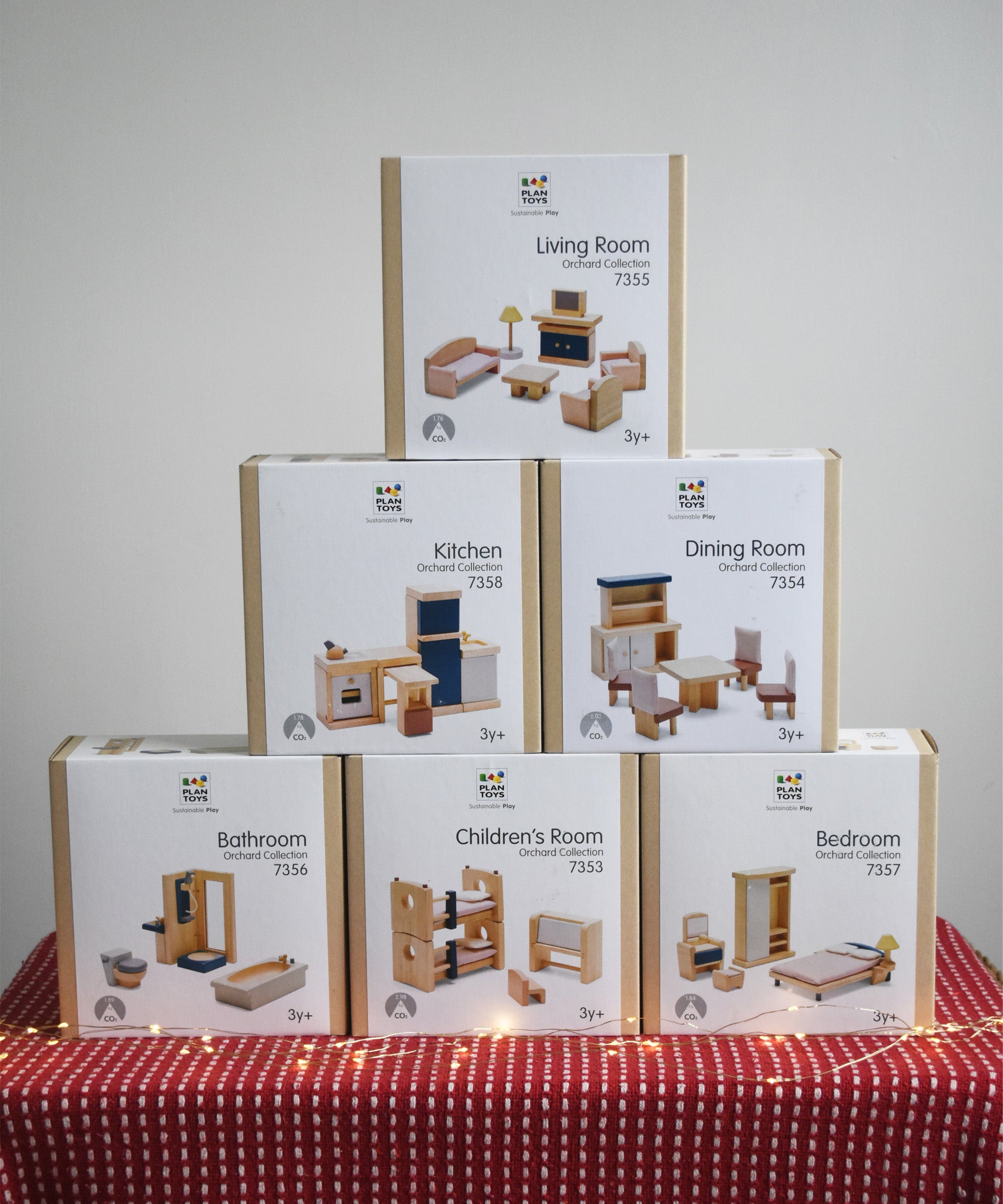 Six boxes of PlanToys wooden dollhouse furniture, stacked in a large discounted bundle at Babipur. 