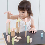A child playing with the PlanToys Pastel Blocks set. 