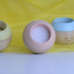 Plan Toys Pastel Sensory Tumbling placed on a yellow cloth. 