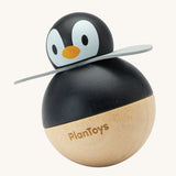 PlanToys Penguin Wobbler wooden baby toy. A circular shaped penguin toy that wobbles when placed on a flat surface. PlanToys range of toys are made from sustainably sourced rubberwood, we're proud stockists of PlanToys here at Babipur. 