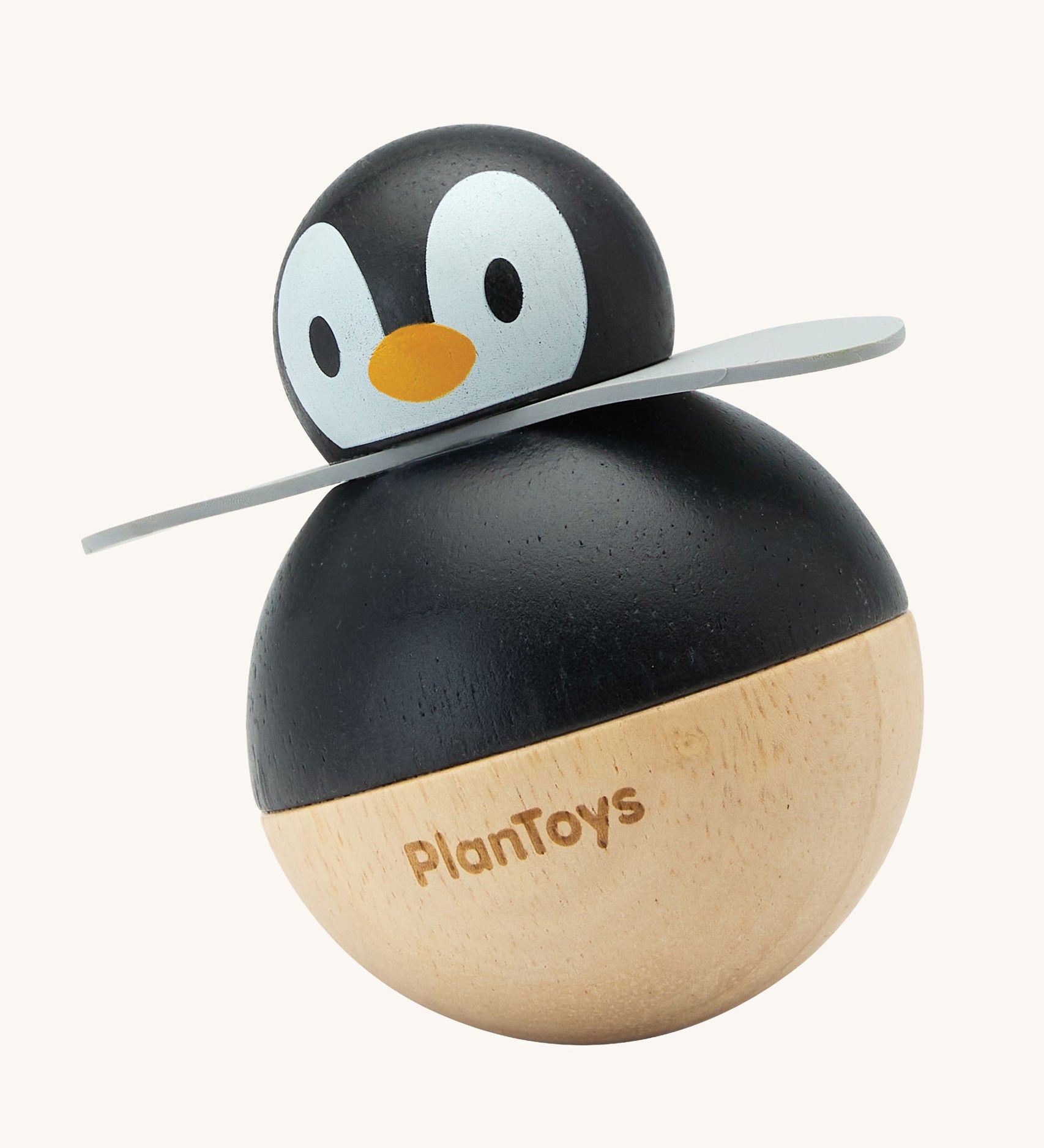 PlanToys Penguin Wobbler wooden baby toy. A circular shaped penguin toy that wobbles when placed on a flat surface. PlanToys range of toys are made from sustainably sourced rubberwood, we're proud stockists of PlanToys here at Babipur. 