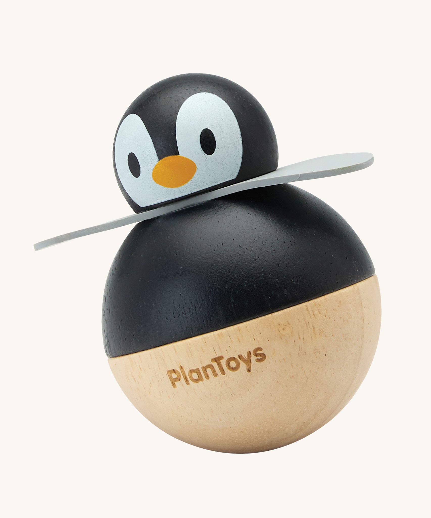 PlanToys Penguin Wobbler wooden baby toy. A circular shaped penguin toy that wobbles when placed on a flat surface. PlanToys range of toys are made from sustainably sourced rubberwood, we're proud stockists of PlanToys here at Babipur. 
