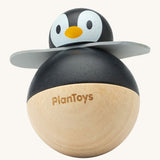 PlanToys Penguin Wobbler wooden baby toy. A circular shaped penguin toy that wobbles when placed on a flat surface. PlanToys range of toys are made from sustainably sourced rubberwood, we're proud stockists of PlanToys here at Babipur. 