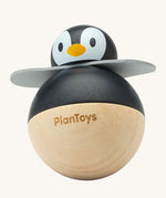 PlanToys Penguin Wobbler wooden baby toy. A circular shaped penguin toy that wobbles when placed on a flat surface. PlanToys range of toys are made from sustainably sourced rubberwood, we're proud stockists of PlanToys here at Babipur. 