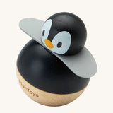 PlanToys Penguin Wobbler wooden baby toy. A circular shaped penguin toy that wobbles when placed on a flat surface. PlanToys range of toys are made from sustainably sourced rubberwood, we're proud stockists of PlanToys here at Babipur. 