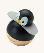 PlanToys Penguin Wobbler wooden baby toy. A circular shaped penguin toy that wobbles when placed on a flat surface. PlanToys range of toys are made from sustainably sourced rubberwood, we're proud stockists of PlanToys here at Babipur. 