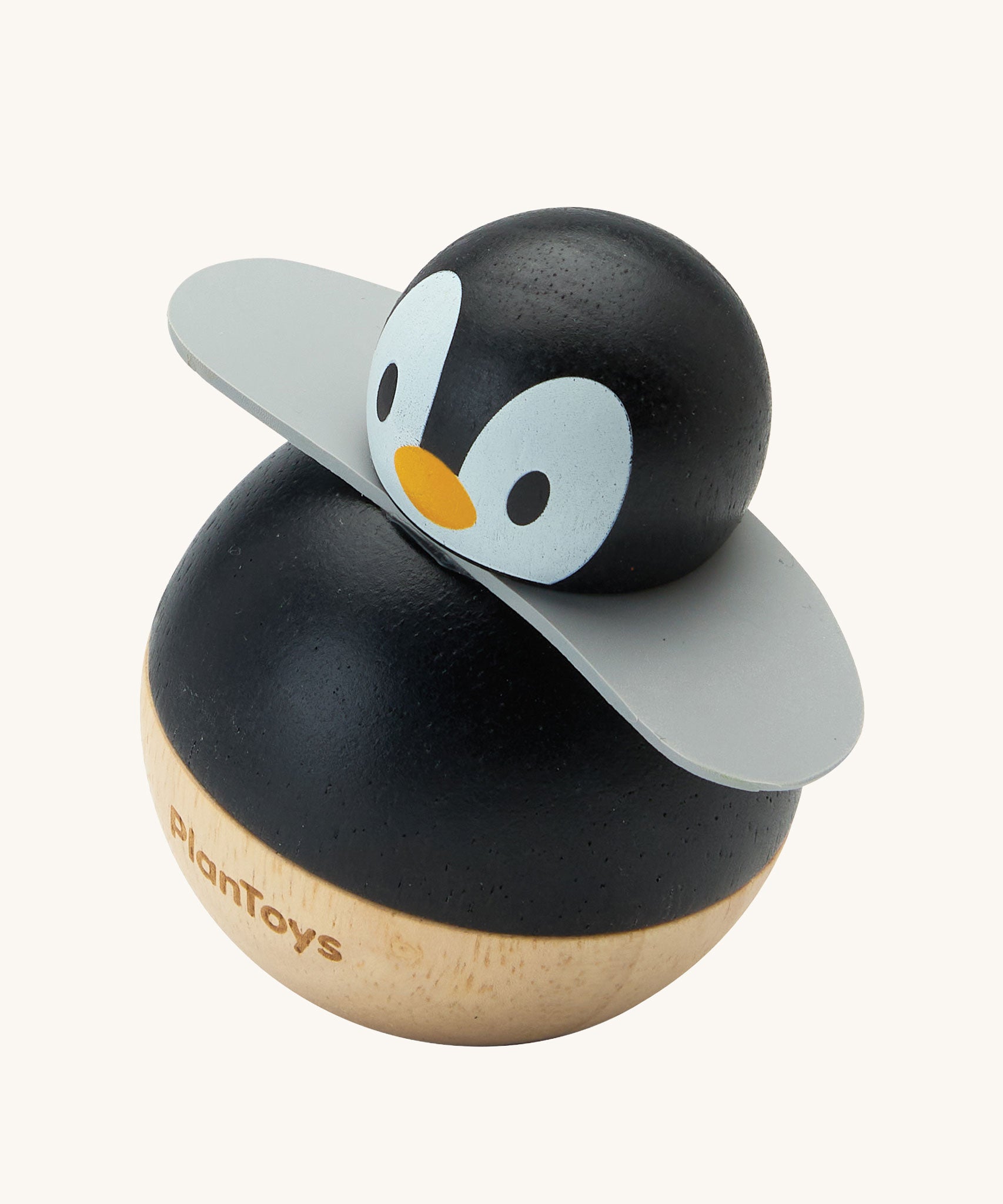 PlanToys Penguin Wobbler wooden baby toy. A circular shaped penguin toy that wobbles when placed on a flat surface. PlanToys range of toys are made from sustainably sourced rubberwood, we're proud stockists of PlanToys here at Babipur. 