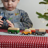 A child playing with the PlanToys Planworld Cars on the PlanToys rubber road.