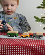 A child playing with the PlanToys Planworld Cars on the PlanToys rubber road.