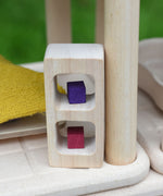 The shelves from the PlanToys PlanSpace bedroom set. Little wooden cubes from the Grapat mis and match set have been placed on the shelves.