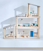 A full setup including all PlanToys wooden planspace sets stacked on top of eachother creating a space dolls house setup. 