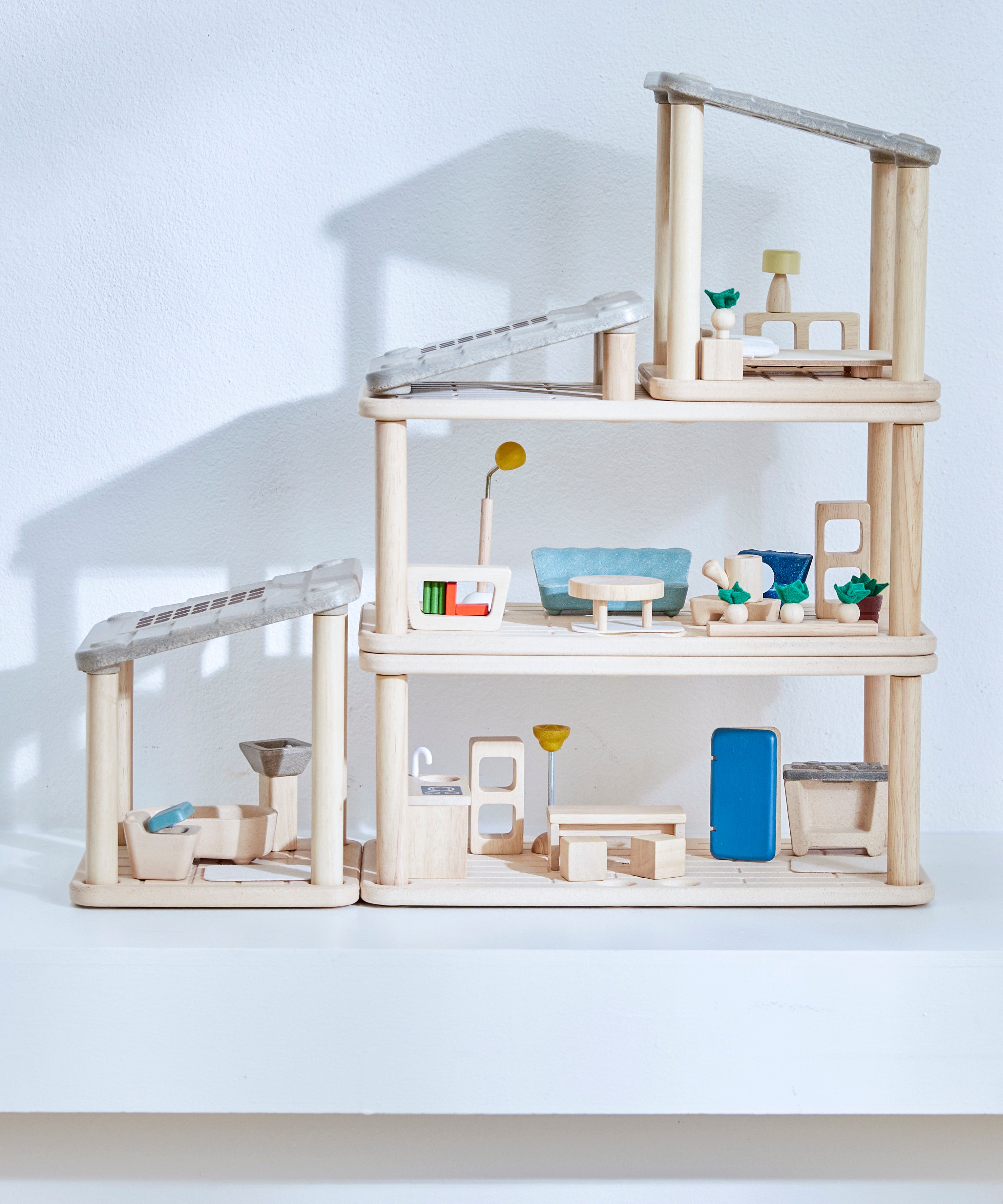 A full setup including all PlanToys wooden planspace sets stacked on top of eachother creating a space dolls house setup. 