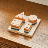 PlanToys wooden orchard shape sorting toy set on a wooden worktop