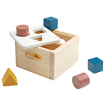 PlanToys wooden shape and sort it out toy box on a white background next to some wooden blocks