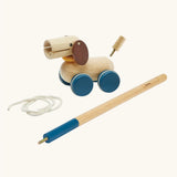 PlanToys push and pull puppy wooden toy. Wooden dog with brown ears and blue wheels that comes with a sting and a screw in stick so that it can be either pulled or pushed along. 