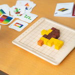 A lion  shape created using the PlanToys 100 Rainbow Counting Cubes, the card with the lion pattern can be seen at the side. 