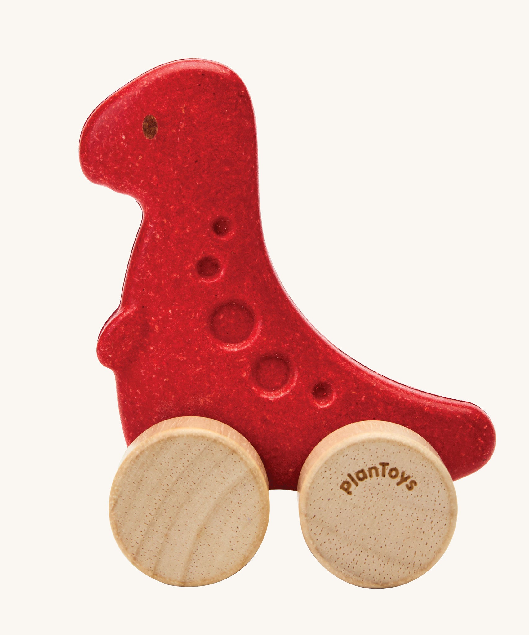 PlanToys dino rex wooden car toy. A red coloured, wooden tyrannosaurus rex dinosaur figure toy on wheels. PlanToys range of toys are made from sustainably sourced rubberwood, we're proud stockists of PlanToys here at Babipur. 