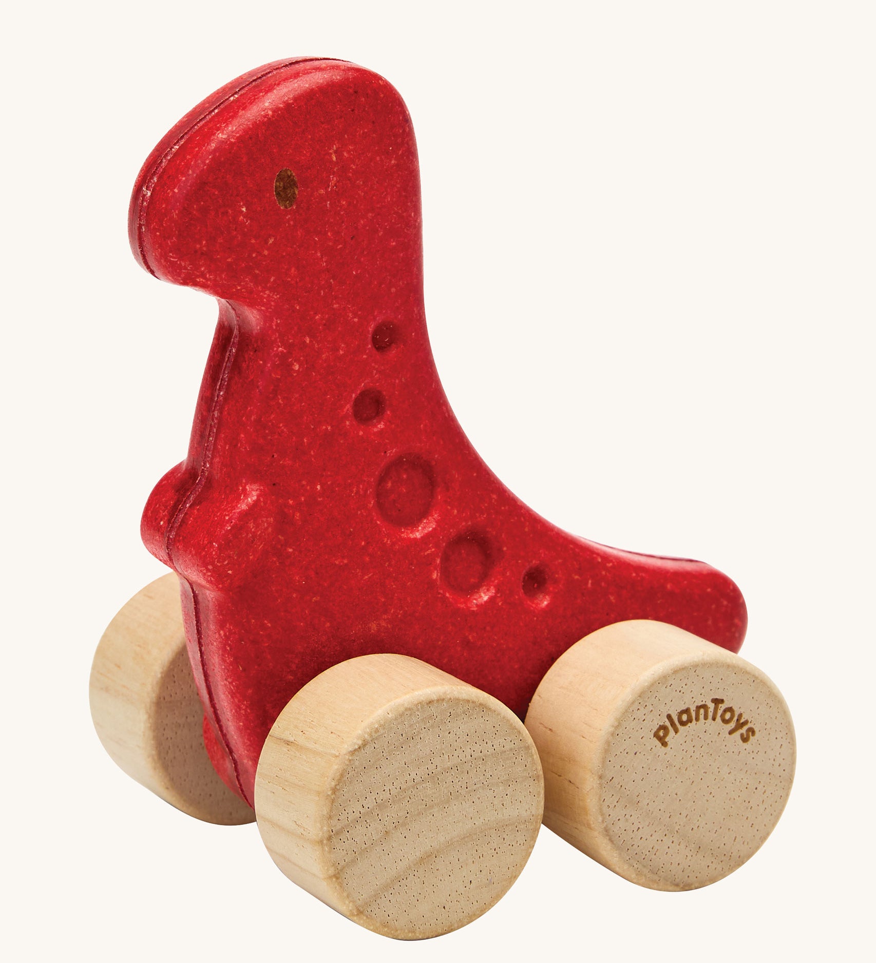 PlanToys dino rex wooden car toy. A red coloured, wooden tyrannosaurus rex dinosaur figure toy on wheels. PlanToys range of toys are made from sustainably sourced rubberwood, we're proud stockists of PlanToys here at Babipur. 
