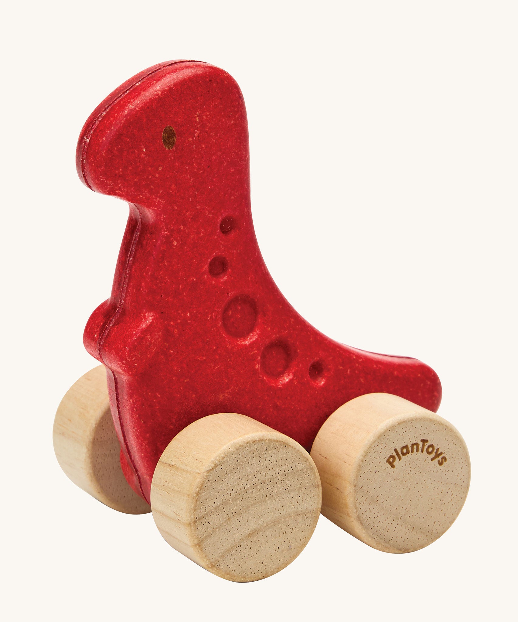 PlanToys dino rex wooden car toy. A red coloured, wooden tyrannosaurus rex dinosaur figure toy on wheels. PlanToys range of toys are made from sustainably sourced rubberwood, we're proud stockists of PlanToys here at Babipur. 