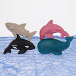 The PlanToys Sea Life animals Set pictured on a blue Ostheimer scarf. 