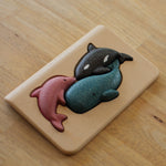 PlanToys Sea Life Puzzle with the pieces shown in the puzzle base on a wooden table. 