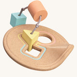 The PlanToys Shape Sorter in pastel shades on a plain background. 