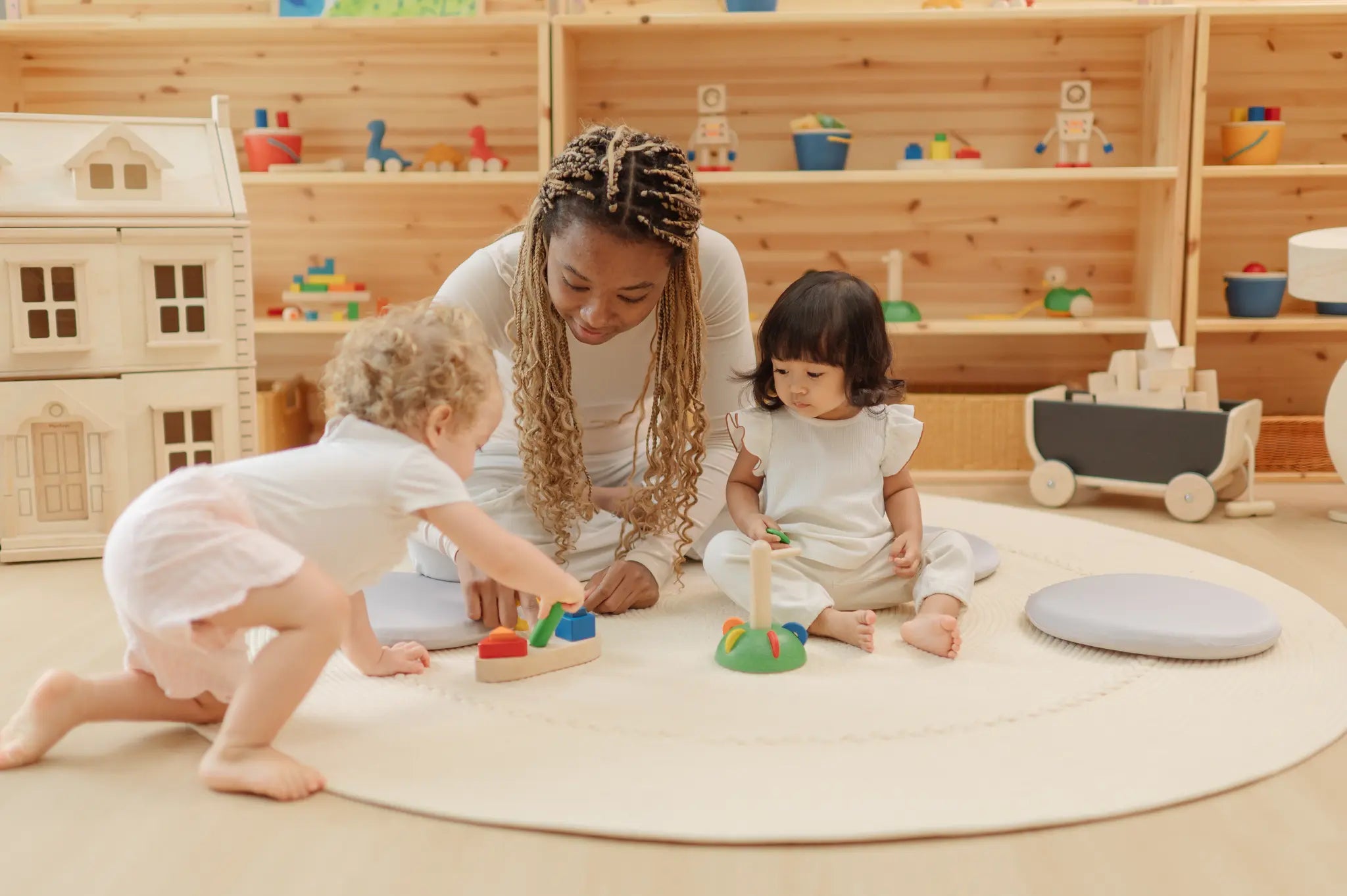 Children playing with the PlanToys sorting boat wooden shape sorting toy with an adult helping. 