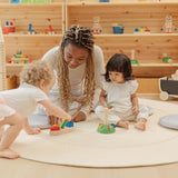 Children playing with the PlanToys sorting boat wooden shape sorting toy with an adult helping. 