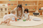 Children playing with the PlanToys sorting boat wooden shape sorting toy with an adult helping. 