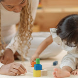 Child playing with the PlanToys sorting boat wooden shape sorting toy. 