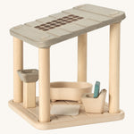 PlanToys wooden space bathroom set. Features a toy sink, bath, toilet and small rug. 