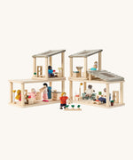 A full dollhouse setup including the PlanToys space bathroom, kitchen and living room sets with various PlanToys family dolls