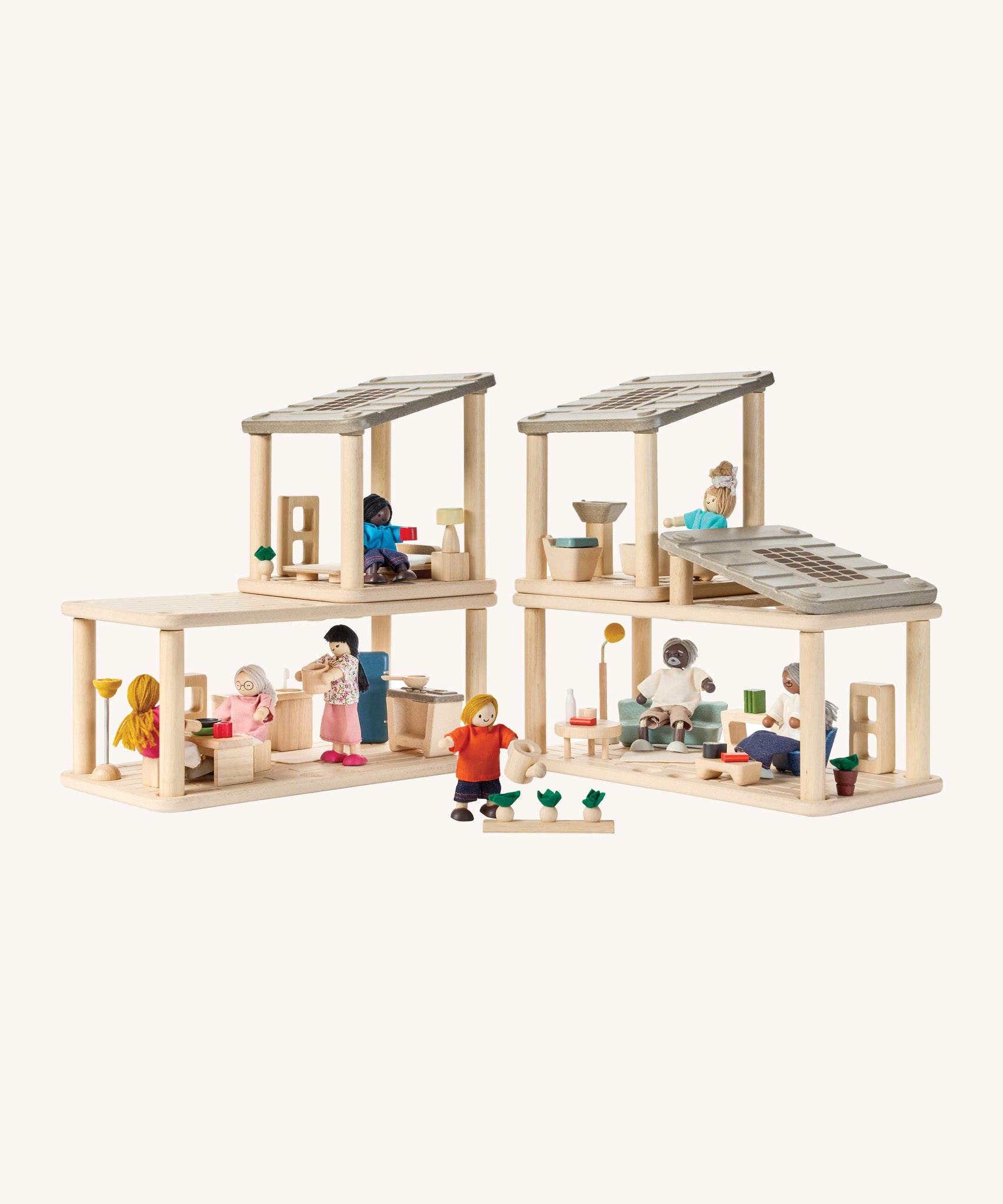 A full dollhouse setup including the PlanToys space bathroom, kitchen and living room sets with various PlanToys family dolls