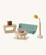 A close up view of the other PlanToys wooden space living room accessories including a sofa, coffee table, lamp and a small table