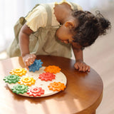 Child playing with the PlanToys spinning gear wooden toy playset.