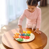 Child playing with the PlanToys spinning gear wooden toy playset.