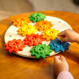 Child playing with the PlanToys spinning gear wooden toy playset.