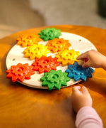 Child playing with the PlanToys spinning gear wooden toy playset.