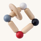 PlanToys Square Clutcher wooden baby toy. A square stretchy shape made of wooden pieces and white, grey, black and red coloured balls. PlanToys range of toys are made from sustainably sourced rubberwood, we're proud stockists of PlanToys here at Babipur. 