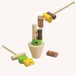 The PlanToys Stacking Logs Game on a plain background, some pieces are on the sticks and some are on the base. 